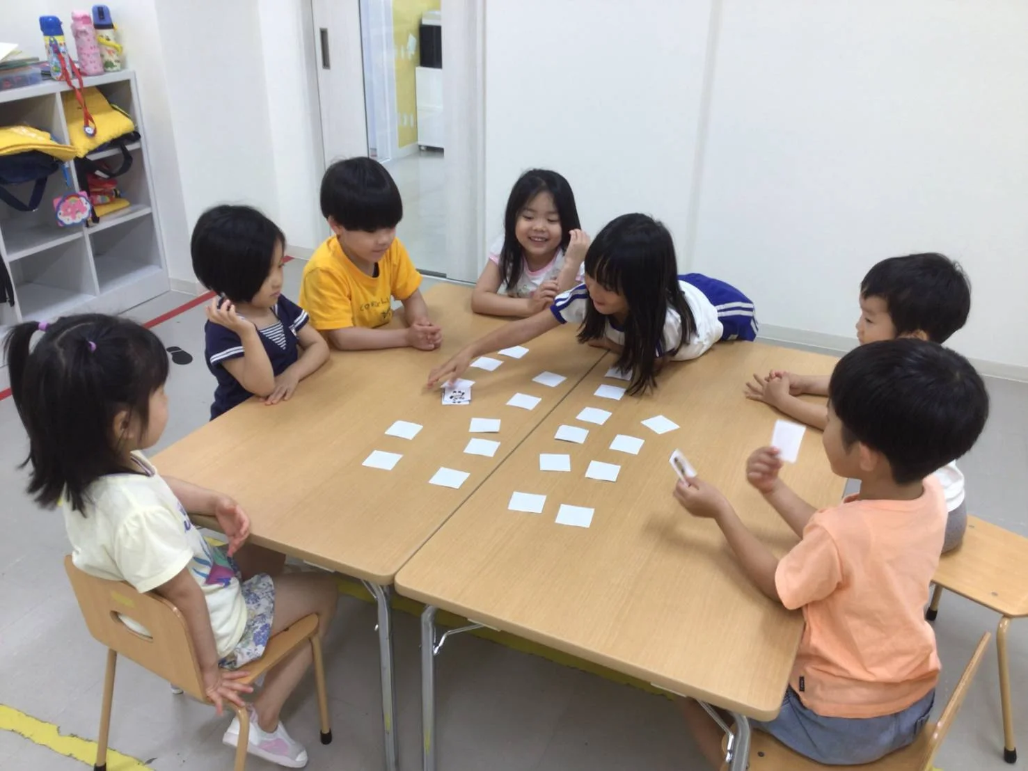 教室でカードゲームをする子どもたち